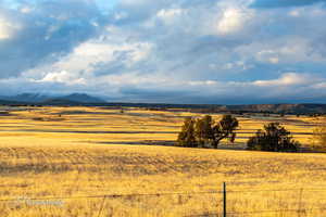 View of mountain background featuring rural landscape