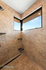 Full bath with a tile shower