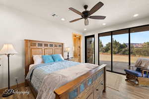 Bedroom with access to outside, recessed lighting, wood finished floors, and a ceiling fan