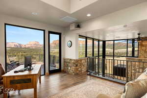Sunroom / solarium with wood-type flooring and recessed lighting