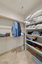 Spacious closet featuring stone tile floors