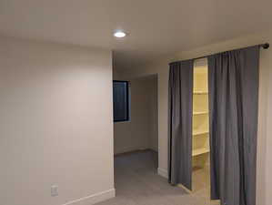 Hall featuring light colored carpet and recessed lighting