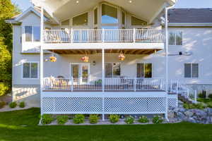 Rear view of house with stucco siding and a deck