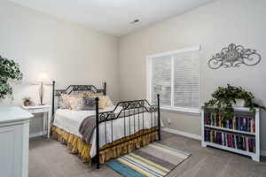 Carpeted bedroom featuring baseboards