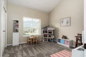 Game room featuring dark carpet and baseboards