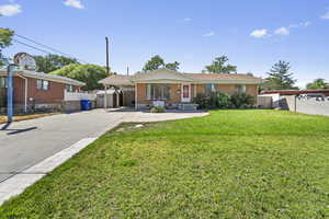 Ranch-style home with brick siding, concrete driveway, and a carport