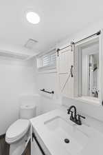 Bathroom with vanity and dark wood-style flooring