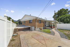 Rear view of property featuring brick siding and a patio area
