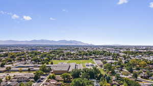 Aerial perspective of suburban area featuring a mountain backdrop