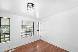 Spare room with wood finished floors and baseboards