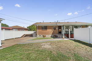 Back of house featuring brick siding
