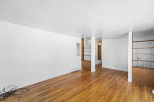 Unfurnished room with wood finished floors and baseboards