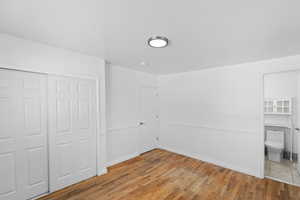 Unfurnished bedroom featuring light wood-type flooring and a closet