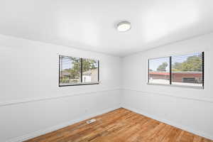 Unfurnished room with light wood-style floors and baseboards