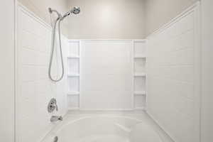 Full bath featuring washtub / shower combination