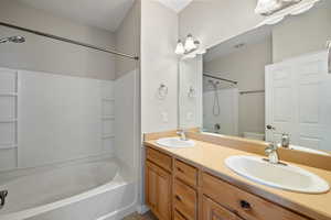 Bathroom featuring tub / shower combination and double vanity