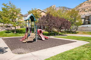 Community playground featuring a yard and a mountain view