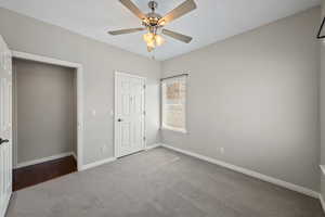 Unfurnished bedroom with carpet flooring and a ceiling fan