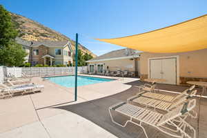 Community pool with a patio and a mountain view
