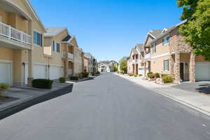 View of asphalt road with curbs and sidewalks