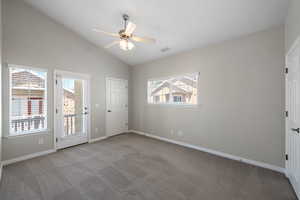 Unfurnished bedroom with carpet floors, access to exterior, ceiling fan, and high vaulted ceiling