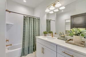 Bathroom with shower / bath combo, vanity, recessed lighting, and light tile patterned flooring