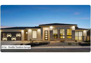 View of front of house featuring stucco siding, driveway, a garage, and stone siding