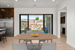 Dining space with recessed lighting and light wood-style floors