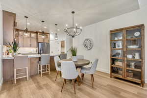 Dining space featuring recessed lighting, light wood-style flooring, and a chandelier