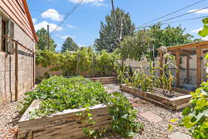 Fenced backyard featuring a vegetable garden