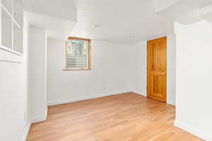Spare room featuring light wood finished floors and a textured ceiling