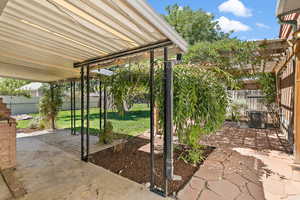 Fenced backyard featuring a patio and a pergola