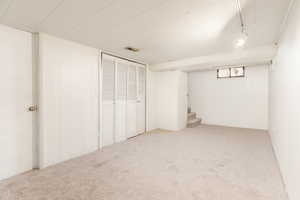 Finished below grade area with carpet floors and wooden walls