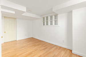 Unfurnished room with light wood-type flooring and a textured ceiling