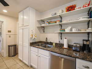 Kitchen with white cabinetry, dishwasher, light tile patterned floors, recessed lighting, and open shelves
