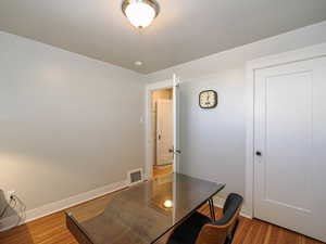 Home office featuring light wood-style floors and baseboards