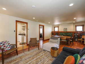 Living area with recessed lighting and light wood-type flooring
