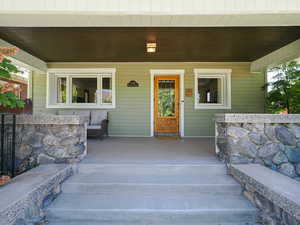 Entrance to property featuring covered porch