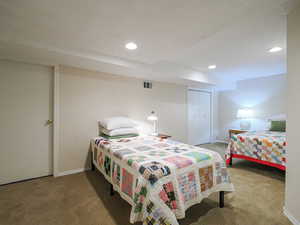 Carpeted bedroom featuring recessed lighting and a closet