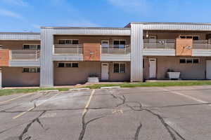 View of property with uncovered parking