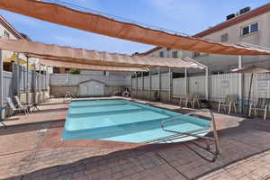 Community pool with a patio