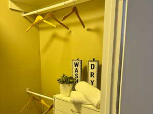 Walk in closet featuring dark wood-style flooring