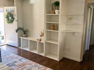 Unfurnished room with dark wood-type flooring and a textured ceiling