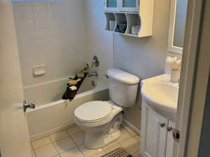 Full bath featuring light tile patterned floors, shower / bath combination, and vanity