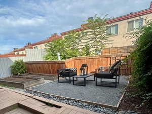 Deck featuring a fenced backyard, a patio, and a garden