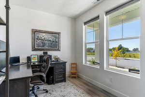 Home office with baseboards and light wood finished floors