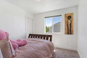 Carpeted bedroom with baseboards and a textured ceiling