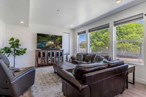 Living room featuring recessed lighting, wood finished floors, and a textured ceiling