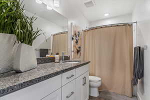Bathroom featuring vanity and a shower with shower curtain