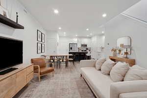 Living room featuring recessed lighting and light wood-style flooring
